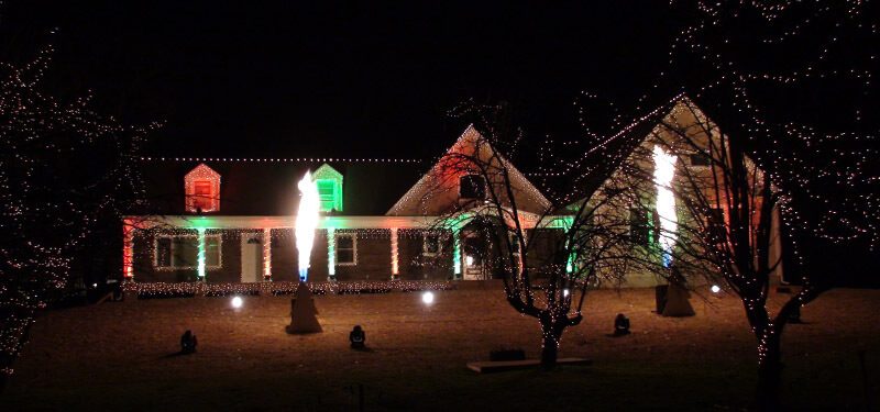 Columns of flame erupting beside the fully lit show house